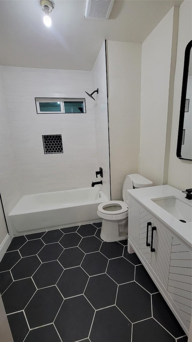 full bathroom featuring vanity, toilet, and tiled shower / bath combo