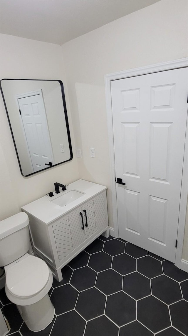 bathroom featuring vanity and toilet