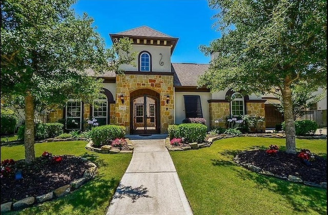 view of front of property with french doors and a front yard