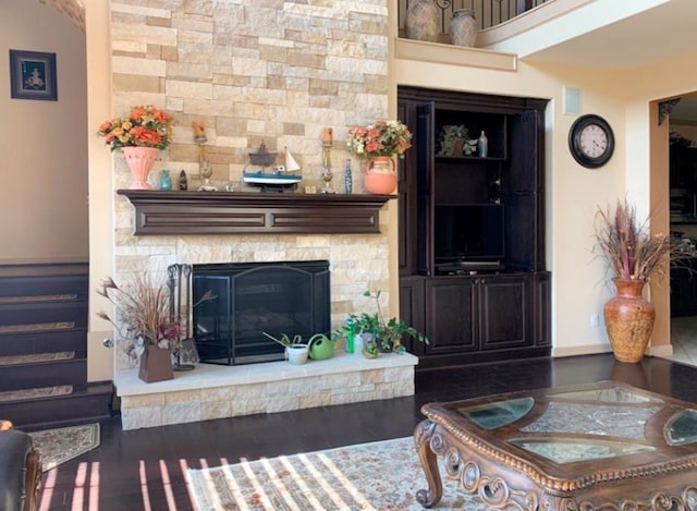 living room featuring a fireplace and dark hardwood / wood-style floors