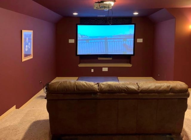 home theater featuring carpet flooring and lofted ceiling