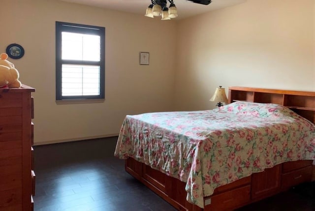 bedroom featuring ceiling fan and dark wood-type flooring