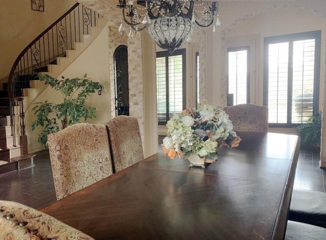 dining space featuring a chandelier, plenty of natural light, and dark wood-type flooring