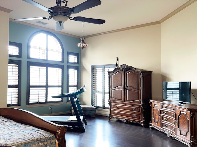 bedroom with dark hardwood / wood-style flooring, ceiling fan, and crown molding