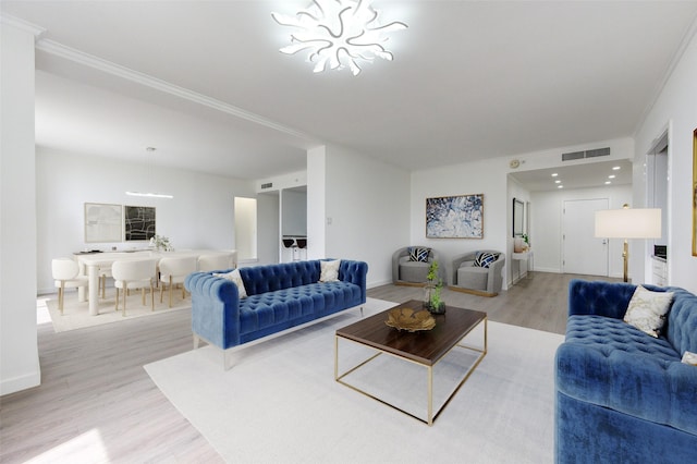 living room with crown molding and light hardwood / wood-style flooring