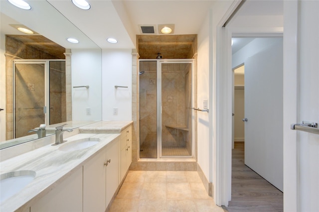 bathroom with vanity and a shower with door