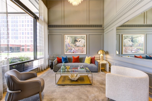 living room with light colored carpet and a high ceiling