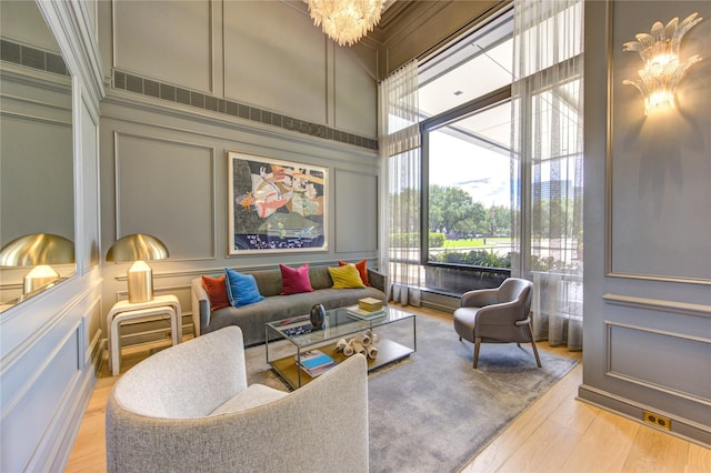 sunroom featuring a wealth of natural light and an inviting chandelier