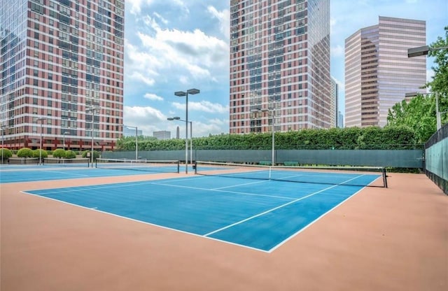 view of tennis court featuring basketball hoop