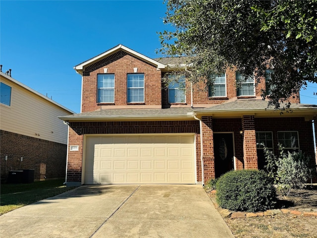 view of front of property featuring a garage and central AC