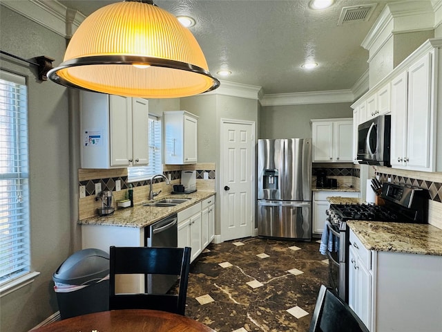 kitchen with white cabinets, decorative backsplash, sink, and appliances with stainless steel finishes