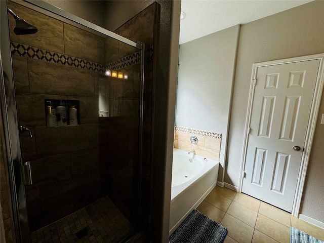 bathroom with tile patterned floors and independent shower and bath