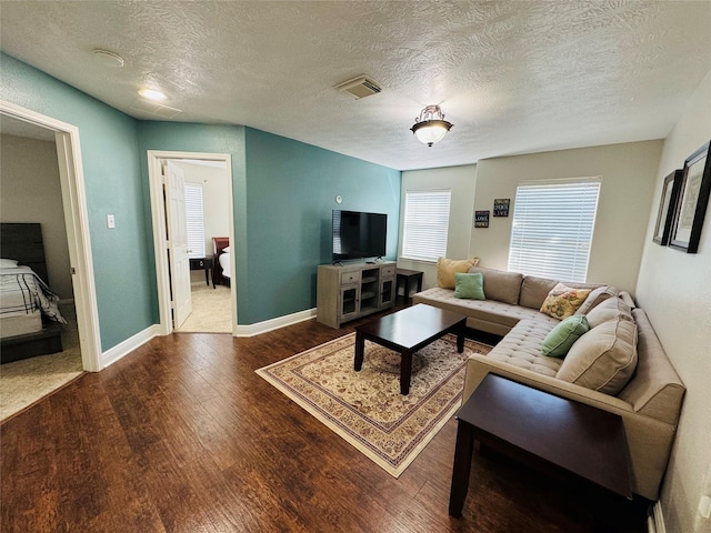 living room featuring a textured ceiling and hardwood / wood-style flooring