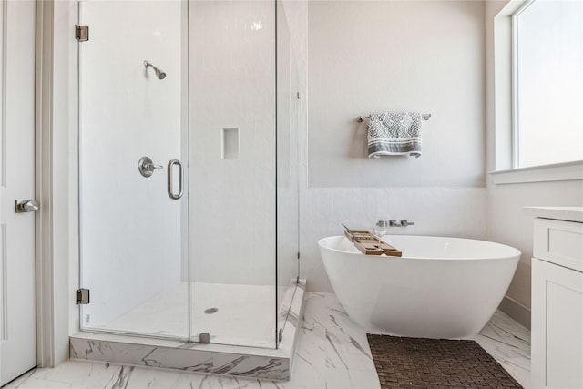 bathroom with separate shower and tub, vanity, and a healthy amount of sunlight