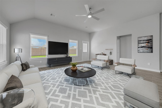 living room featuring a wealth of natural light, ceiling fan, and hardwood / wood-style flooring