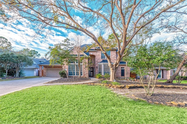 view of front of property featuring a garage and a front lawn