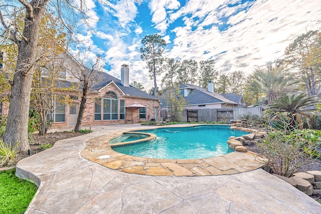 view of pool featuring a patio area and an in ground hot tub