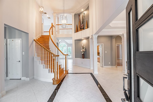 entryway with ornamental molding and a notable chandelier