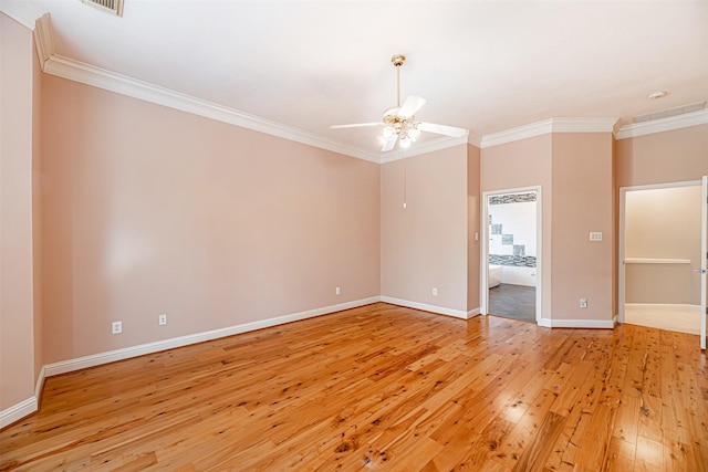 spare room featuring ceiling fan, ornamental molding, and light wood-type flooring