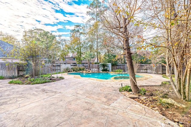 view of pool featuring a patio area and an in ground hot tub