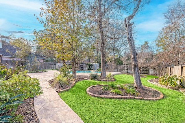 view of yard featuring a patio area and a fenced in pool