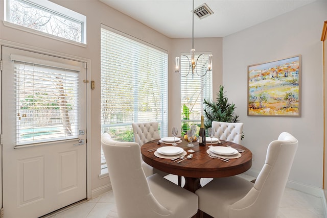 dining room featuring light tile patterned floors and a chandelier