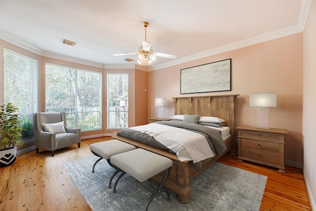 bedroom with ceiling fan, crown molding, and hardwood / wood-style floors