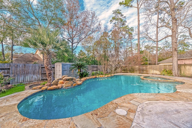 view of pool with an in ground hot tub