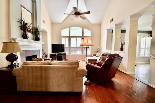 3803 Dewalt Way, Missouri City, TX 77459 - living room featuring ornate columns, ceiling fan, a tile fireplace, wood-type flooring, and lofted ceiling