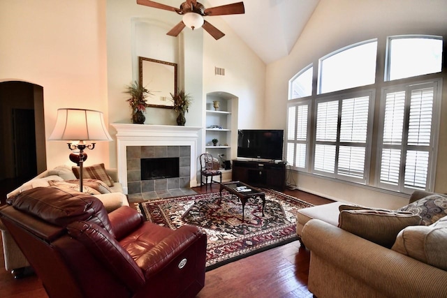 3803 Dewalt Way, Missouri City, TX 77459 - living room with a tiled fireplace, a wealth of natural light, built in features, and hardwood / wood-style flooring