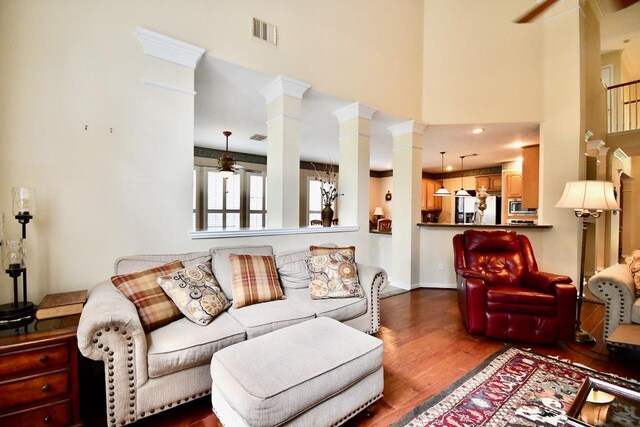 3803 Dewalt Way, Missouri City, TX 77459 - living room featuring dark hardwood / wood-style floors, ceiling fan, a towering ceiling, and ornate columns
