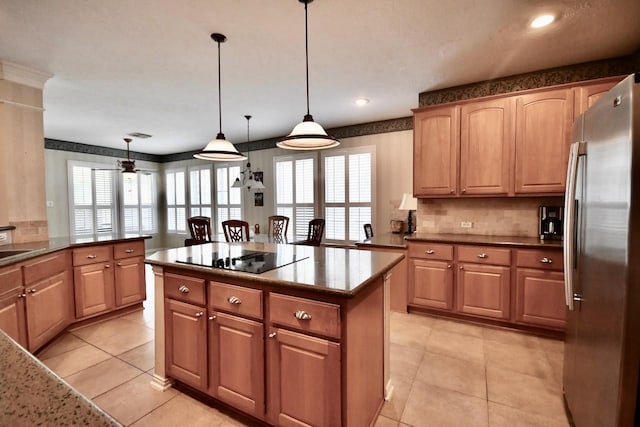 3803 Dewalt Way, Missouri City, TX 77459 - kitchen featuring black electric stovetop, ceiling fan, stainless steel fridge, decorative light fixtures, and kitchen peninsula