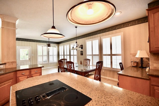 3803 Dewalt Way, Missouri City, TX 77459 - kitchen with ceiling fan, pendant lighting, light tile patterned floors, dark stone countertops, and black stovetop