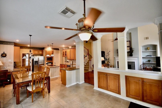 3803 Dewalt Way, Missouri City, TX 77459 - interior space featuring ornate columns, ceiling fan, built in features, a fireplace, and light tile patterned floors