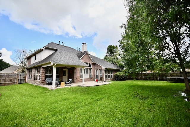 3803 Dewalt Way, Missouri City, TX 77459 - back of house featuring a patio and a lawn