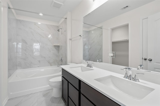 full bathroom with vanity, tiled shower / bath combo, and toilet