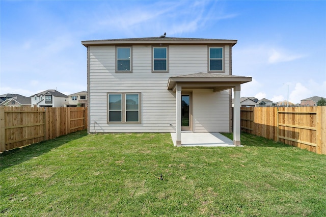 rear view of house featuring a yard and a patio