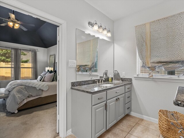 bathroom with tile patterned floors, ceiling fan, lofted ceiling, and vanity