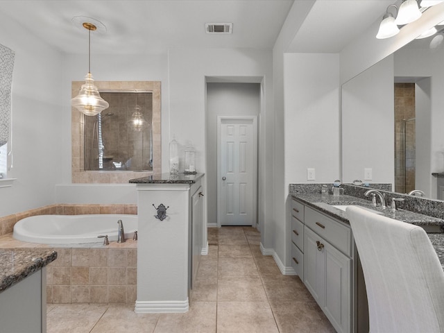 bathroom with tile patterned flooring, vanity, and independent shower and bath