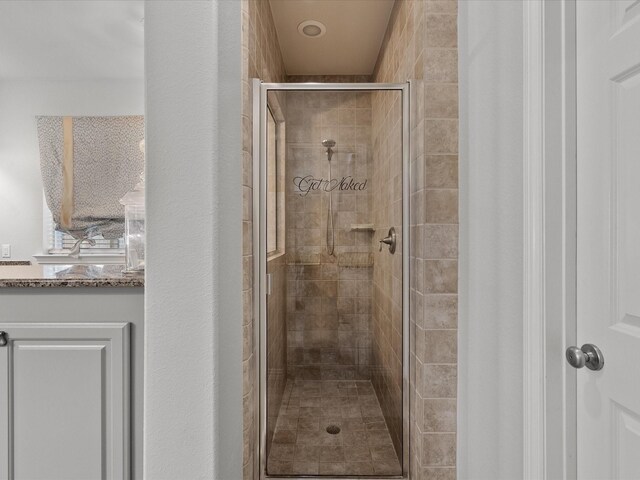 bathroom with a shower with shower door