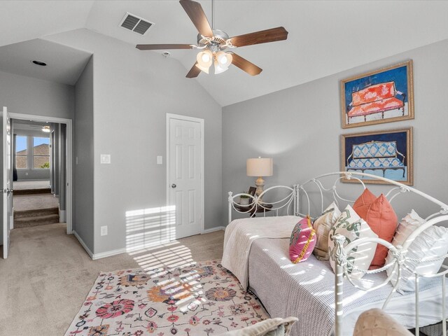 bedroom featuring light carpet, vaulted ceiling, and ceiling fan