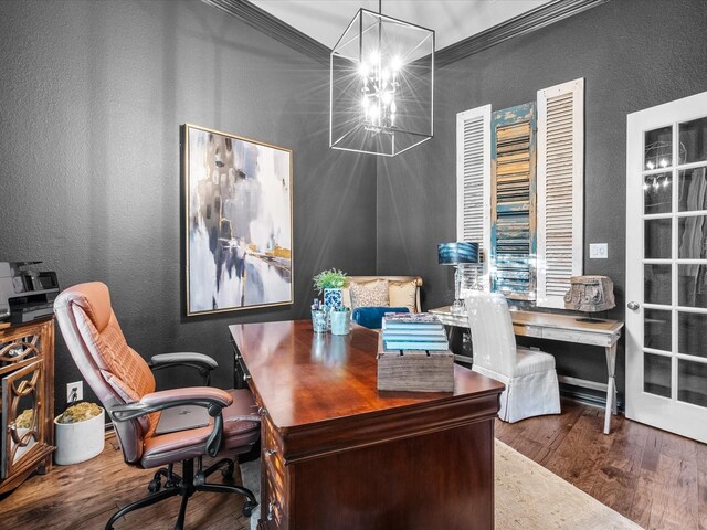 home office featuring wood-type flooring, an inviting chandelier, and ornamental molding