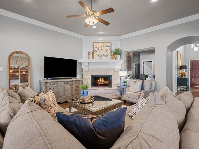 living room with ceiling fan and crown molding