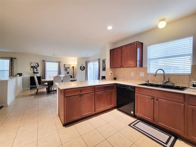 kitchen with dishwasher, kitchen peninsula, sink, and a wealth of natural light