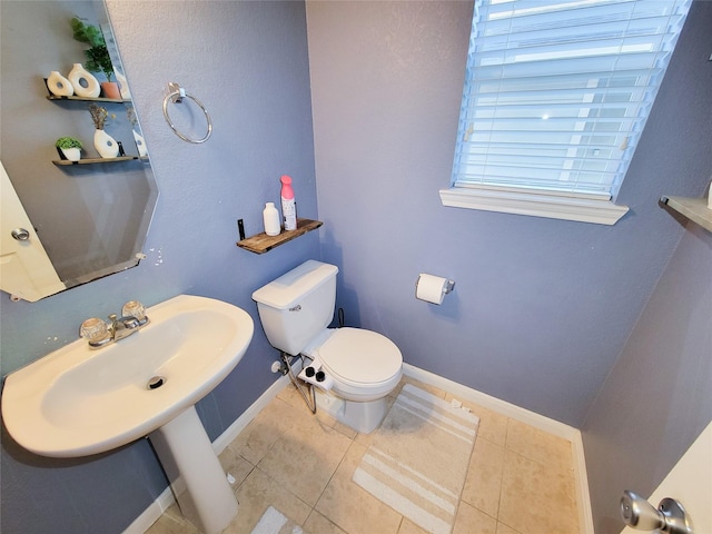 bathroom featuring tile patterned flooring, toilet, and sink