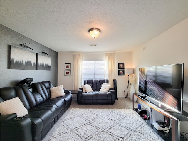 carpeted living room featuring a textured ceiling