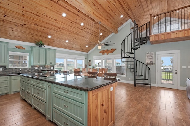 kitchen with green cabinets, a kitchen island, and wood ceiling