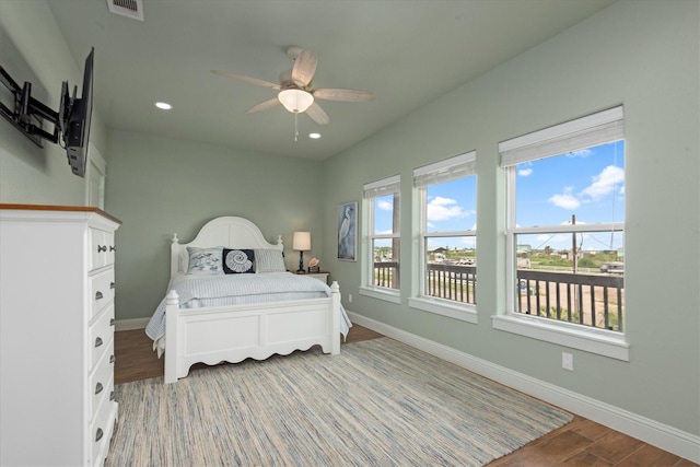 bedroom with hardwood / wood-style floors and ceiling fan