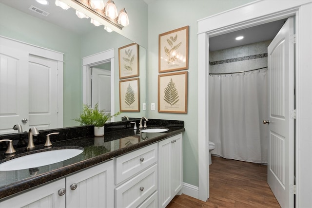 bathroom with vanity, curtained shower, toilet, and wood-type flooring