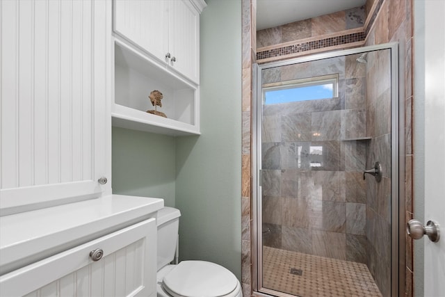 bathroom featuring toilet and walk in shower